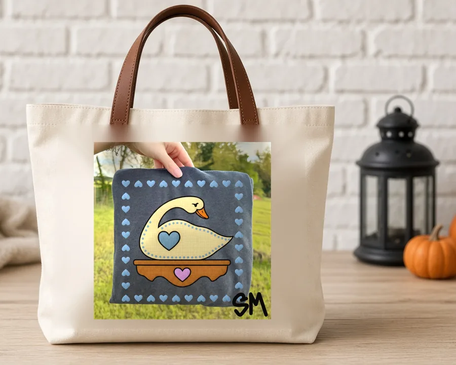 Folk Quilt Swan PNG design on a canvas tote bag