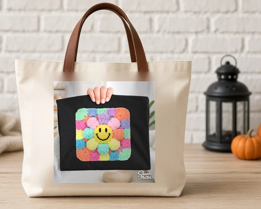 Granny Square Daisy Smiley PNG design on a canvas tote bag
