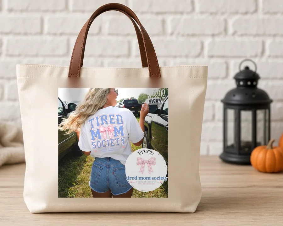 Tired Mom Society PNG design on a canvas tote bag